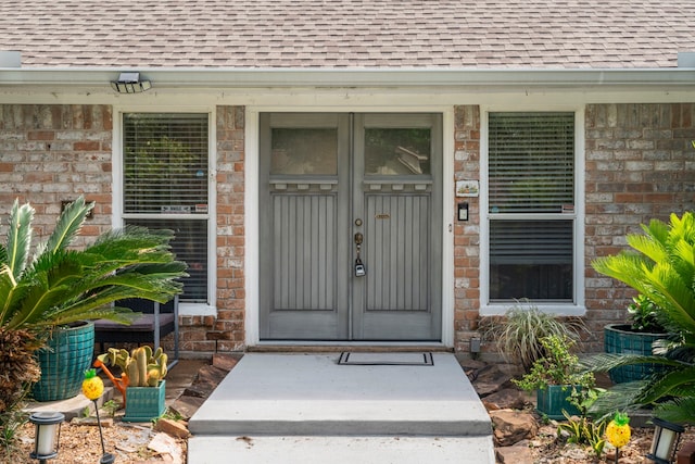 15110 Falling Creek Dr, Houston, TX 77068 - property entrance with roof with shingles and brick siding