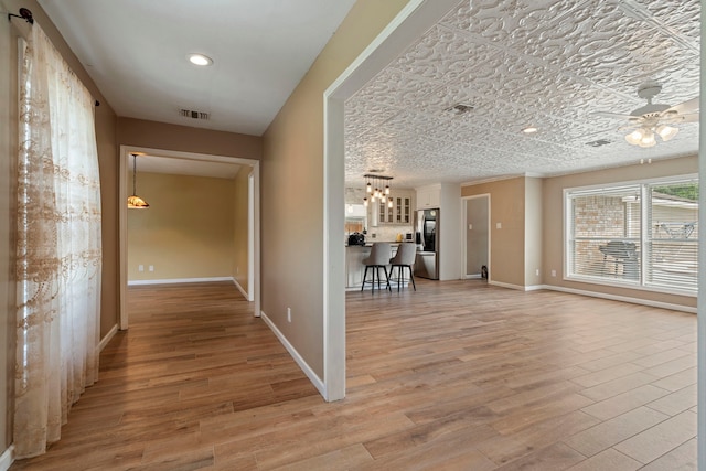 15110 Falling Creek Dr, Houston, TX 77068 - hallway featuring light wood-style floors, baseboards, and a chandelier