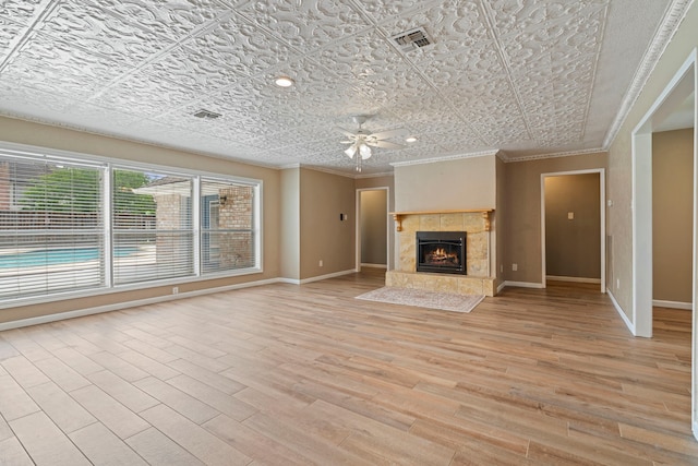 15110 Falling Creek Dr, Houston, TX 77068 - unfurnished living room with a ceiling fan, baseboards, ornamental molding, light wood-style floors, and an ornate ceiling