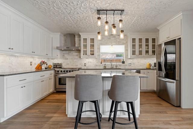 15110 Falling Creek Dr, Houston, TX 77068 - kitchen with appliances with stainless steel finishes, wall chimney exhaust hood, an ornate ceiling, a sink, and tasteful backsplash