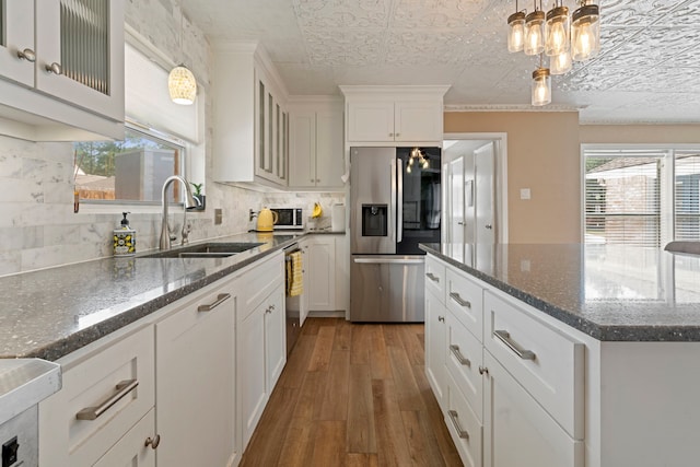 15110 Falling Creek Dr, Houston, TX 77068 - kitchen with stainless steel fridge, a sink, hardwood / wood-style flooring, decorative backsplash, and an ornate ceiling