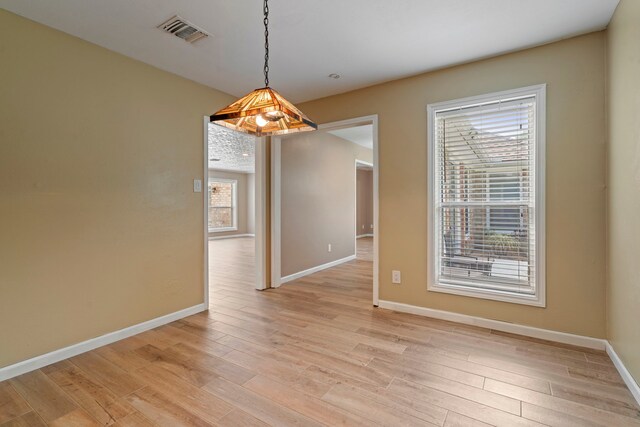 15110 Falling Creek Dr, Houston, TX 77068 - unfurnished dining area featuring light wood-style flooring and baseboards