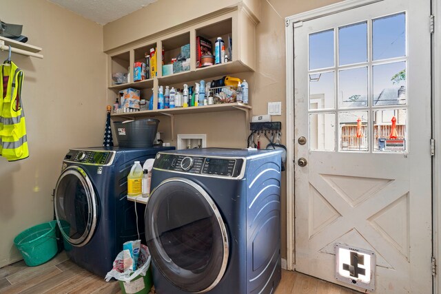 15110 Falling Creek Dr, Houston, TX 77068 - washroom featuring washer and dryer and light wood-style floors