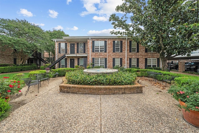 colonial-style house featuring brick siding