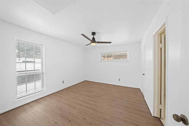 unfurnished room featuring baseboards, a ceiling fan, and wood finished floors