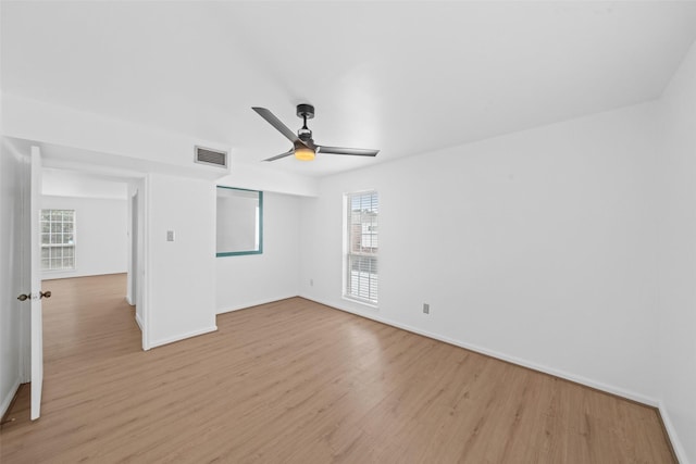 interior space featuring baseboards, visible vents, and light wood-style flooring