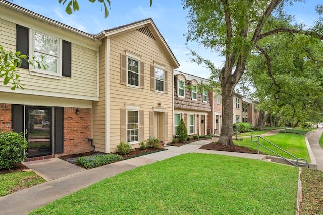 view of front of house featuring a front yard and brick siding