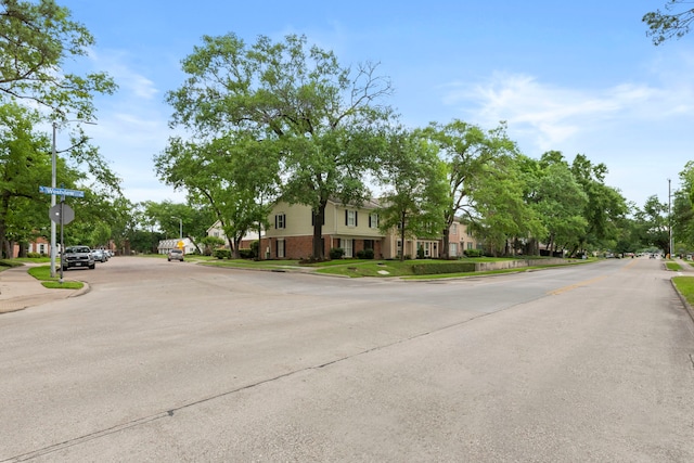 view of street with traffic signs, curbs, and sidewalks