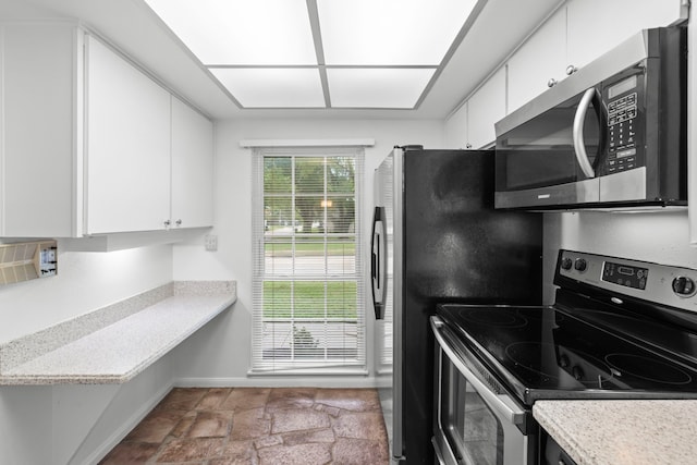 kitchen featuring light countertops, white cabinets, and appliances with stainless steel finishes