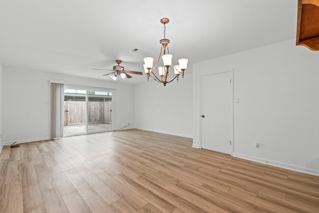 unfurnished room with light wood-type flooring, visible vents, baseboards, and ceiling fan with notable chandelier