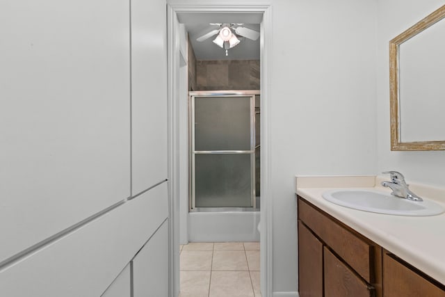 bathroom featuring tile patterned floors, a ceiling fan, enclosed tub / shower combo, and vanity