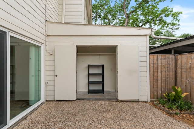 view of exterior entry featuring fence