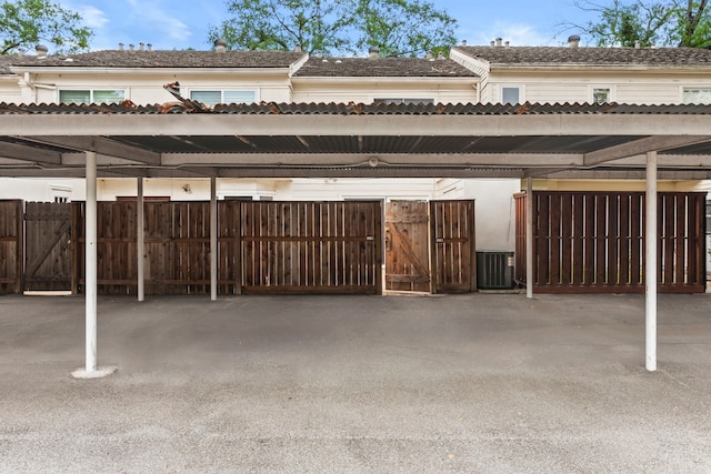 exterior space featuring central air condition unit and fence