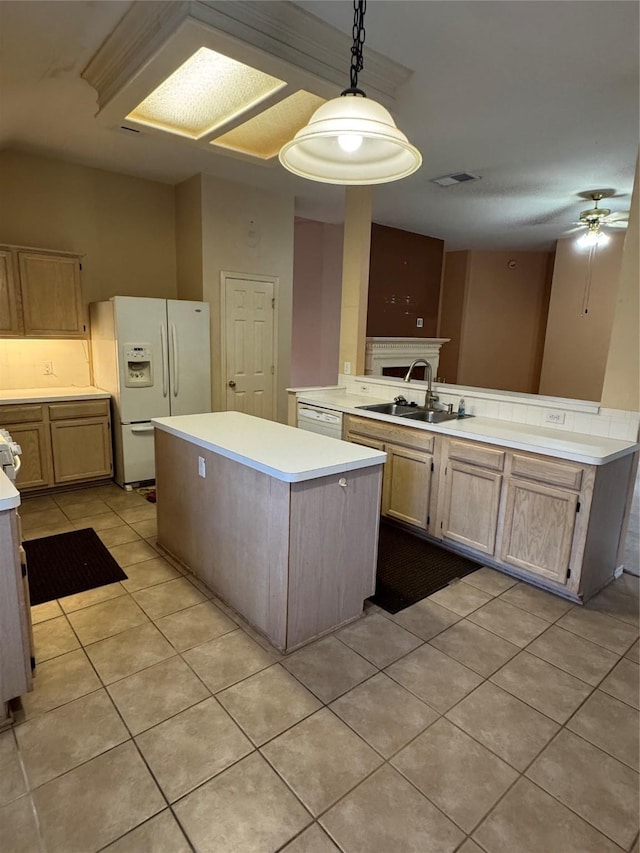 kitchen featuring light tile patterned flooring, a sink, white appliances, light countertops, and a center island