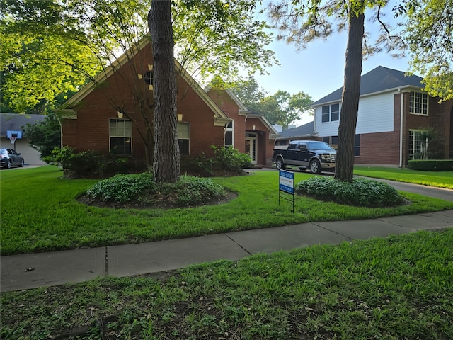 view of side of property with a yard and brick siding