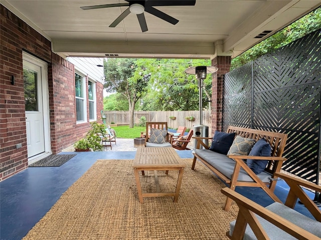 view of patio / terrace featuring a fenced backyard, ceiling fan, and outdoor lounge area