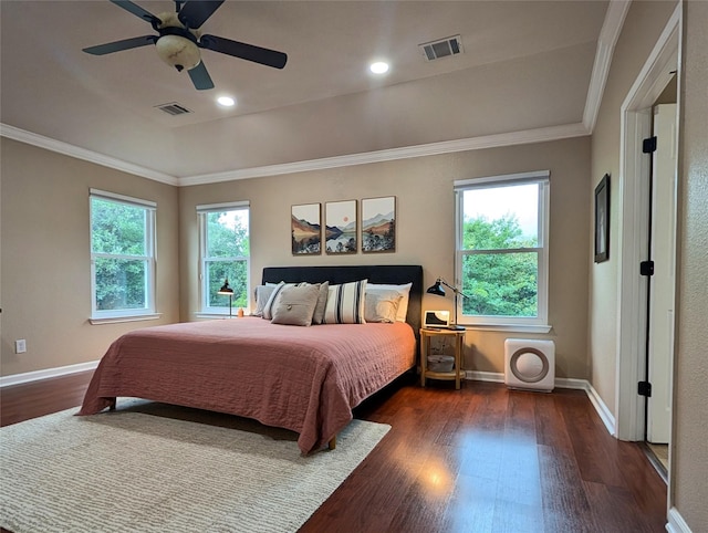 bedroom with baseboards, visible vents, ornamental molding, and wood finished floors