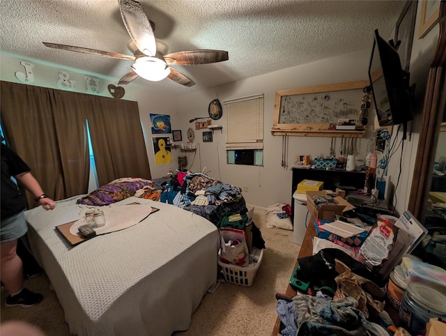 bedroom with carpet flooring, a textured ceiling, and a ceiling fan