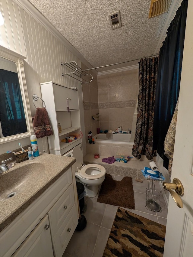 full bath with a textured ceiling, tile patterned floors, toilet, ornamental molding, and tiled shower / bath combo
