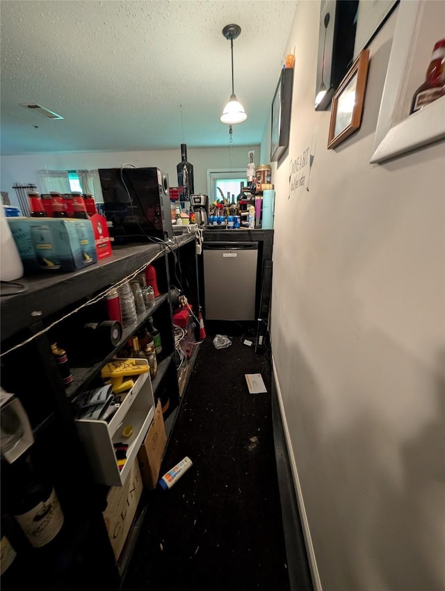 interior space featuring a textured ceiling, carpet, and dishwashing machine