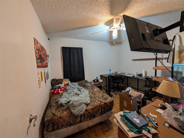 bedroom with a ceiling fan and a textured ceiling
