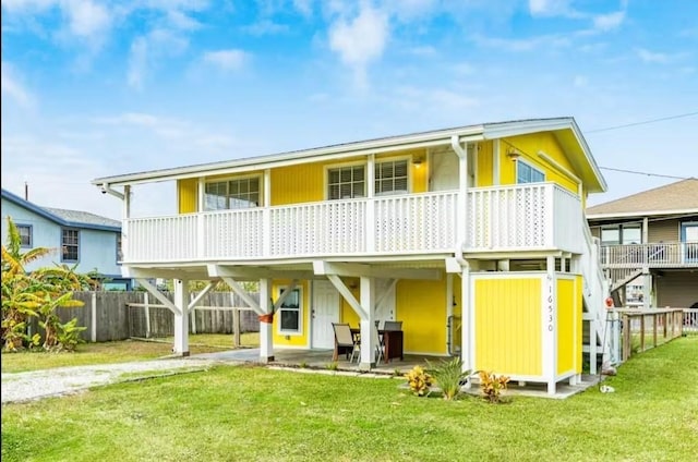 16530 Jean Lafitte Rd, Jamaica Beach, TX 77554 - rear view of property with a yard, fence, driveway, and a carport