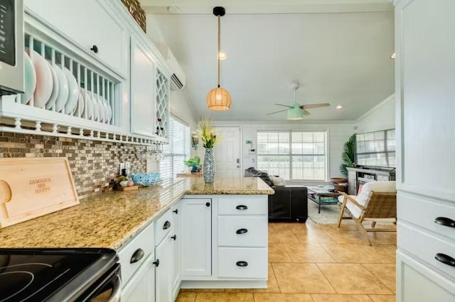16530 Jean Lafitte Rd, Jamaica Beach, TX 77554 - kitchen featuring ceiling fan, tasteful backsplash, light tile patterned floors, light stone counters, and white cabinetry