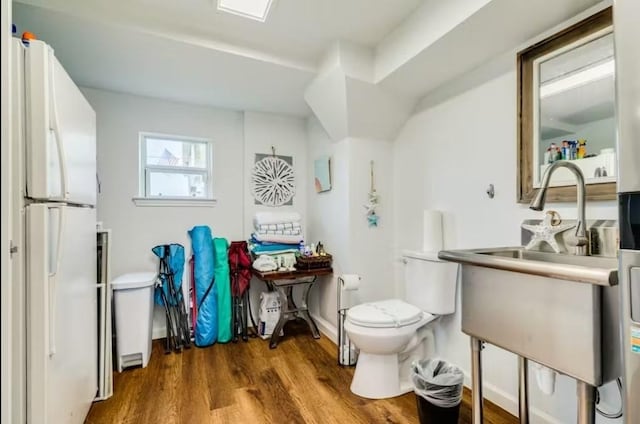 16530 Jean Lafitte Rd, Jamaica Beach, TX 77554 - bathroom with a sink, baseboards, toilet, and wood finished floors