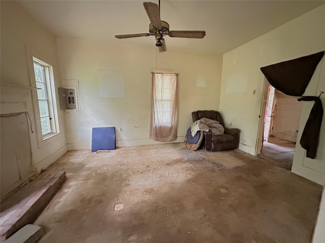unfurnished living room featuring a ceiling fan and electric panel