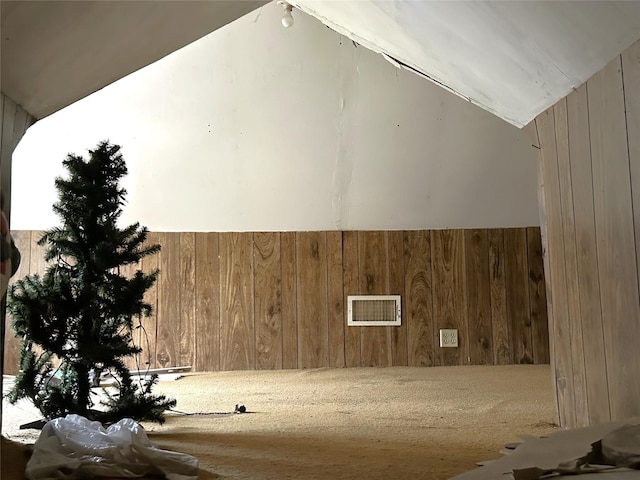 interior space featuring wooden walls and visible vents