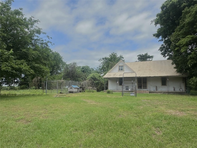 view of yard featuring fence and a porch