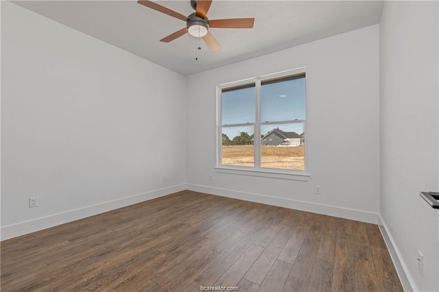 empty room with baseboards, ceiling fan, and wood finished floors