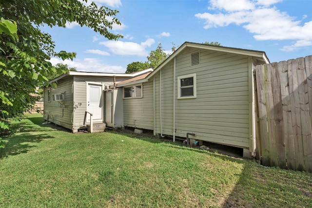 808 Morrell St, Baytown, TX 77520 - back of property with a lawn, fence, a wall mounted air conditioner, and entry steps
