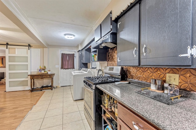808 Morrell St, Baytown, TX 77520 - kitchen featuring washing machine and dryer, a barn door, light tile patterned floors, stainless steel range with gas cooktop, and under cabinet range hood