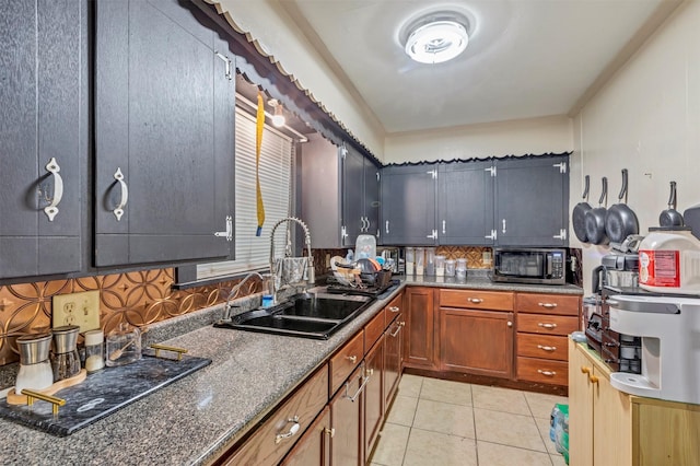 808 Morrell St, Baytown, TX 77520 - kitchen with brown cabinetry, a sink, decorative backsplash, and light tile patterned floors