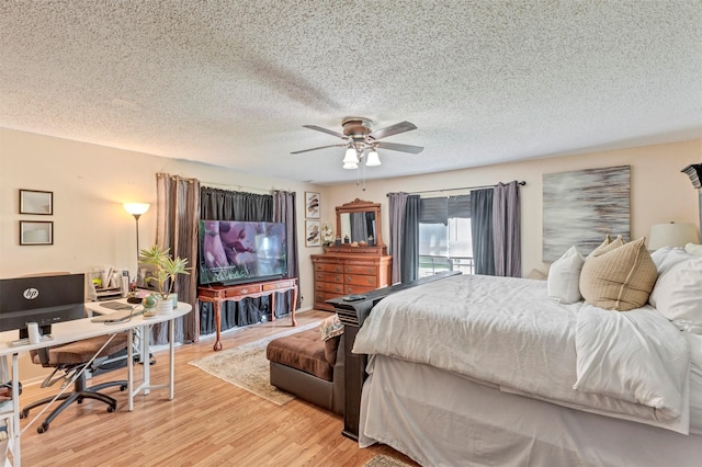 808 Morrell St, Baytown, TX 77520 - bedroom with a textured ceiling, light wood finished floors, and ceiling fan