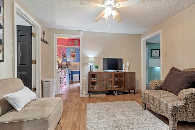 808 Morrell St, Baytown, TX 77520 - living room with a textured ceiling, a ceiling fan, and wood finished floors