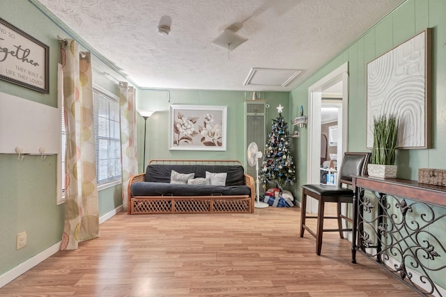 808 Morrell St, Baytown, TX 77520 - sitting room featuring baseboards, attic access, a textured ceiling, and wood finished floors