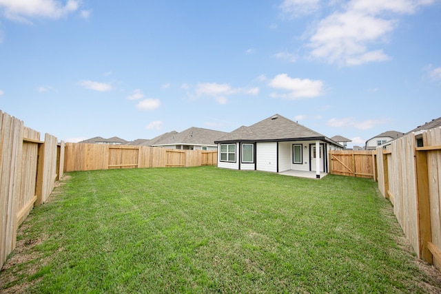back of property with a lawn, a patio, and a fenced backyard