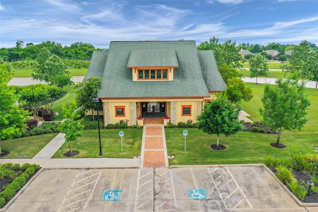 4418 Southpoint Way N, Fulshear, TX 77441 - view of front facade with stone siding, uncovered parking, and a front lawn