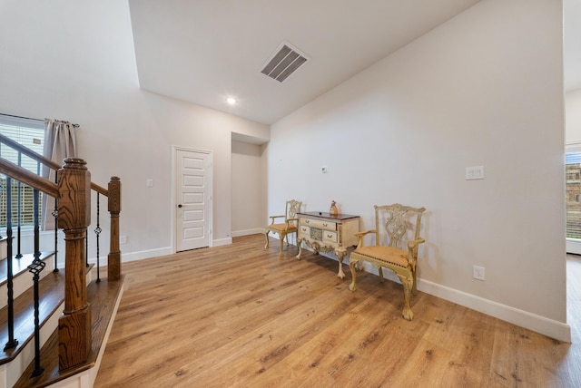 sitting room with baseboards, visible vents, and light wood-type flooring