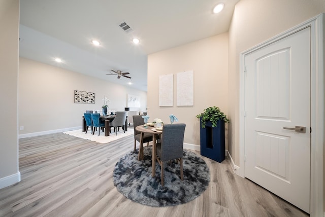 dining area featuring baseboards, visible vents, and light wood-style floors