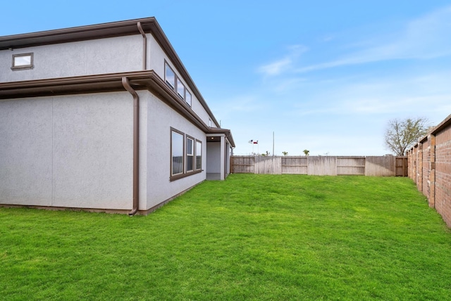 view of yard with a fenced backyard