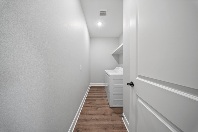 laundry area featuring laundry area, baseboards, visible vents, dark wood-style floors, and washer and clothes dryer