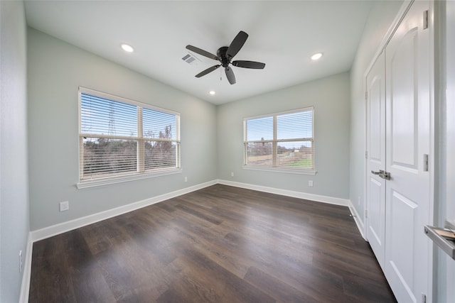 unfurnished bedroom with dark wood-type flooring, recessed lighting, baseboards, and visible vents