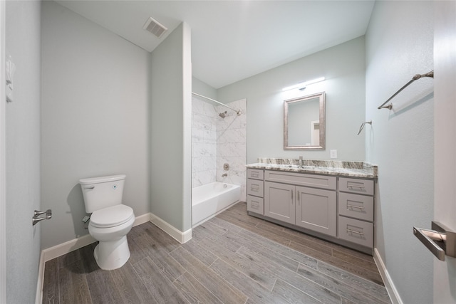 full bath with visible vents, vanity, wood finished floors, toilet, and baseboards