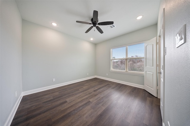 spare room with a ceiling fan, visible vents, baseboards, recessed lighting, and dark wood-type flooring
