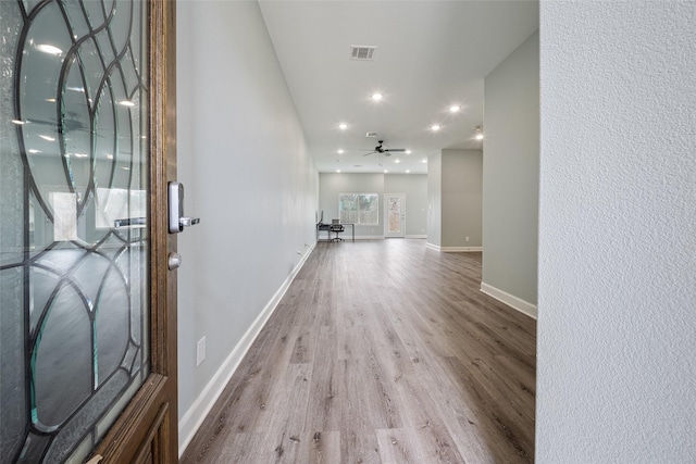 foyer featuring ceiling fan, visible vents, wood finished floors, baseboards, and recessed lighting