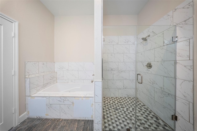 full bath with a garden tub, a stall shower, and wood finished floors