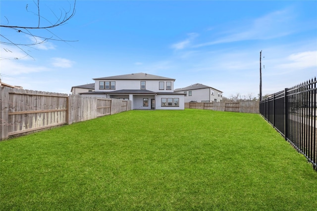 view of yard with a fenced backyard